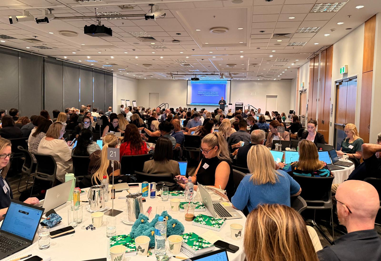 Justin Kabbani presenting to a large audience